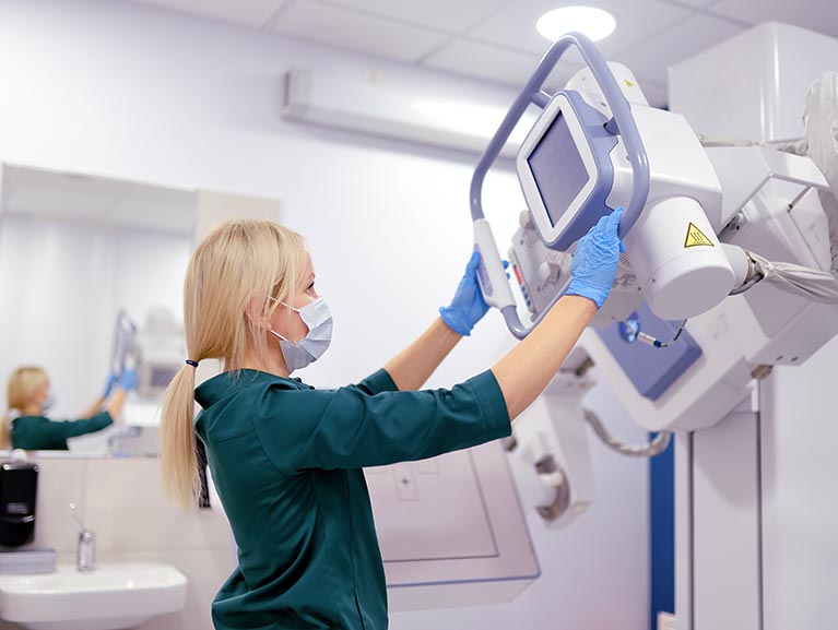 female operating x-ray machine